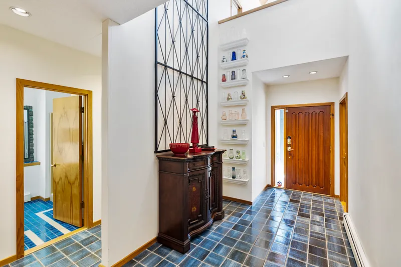 Soaring heights from lower level second entrance with gorgeous blue tile