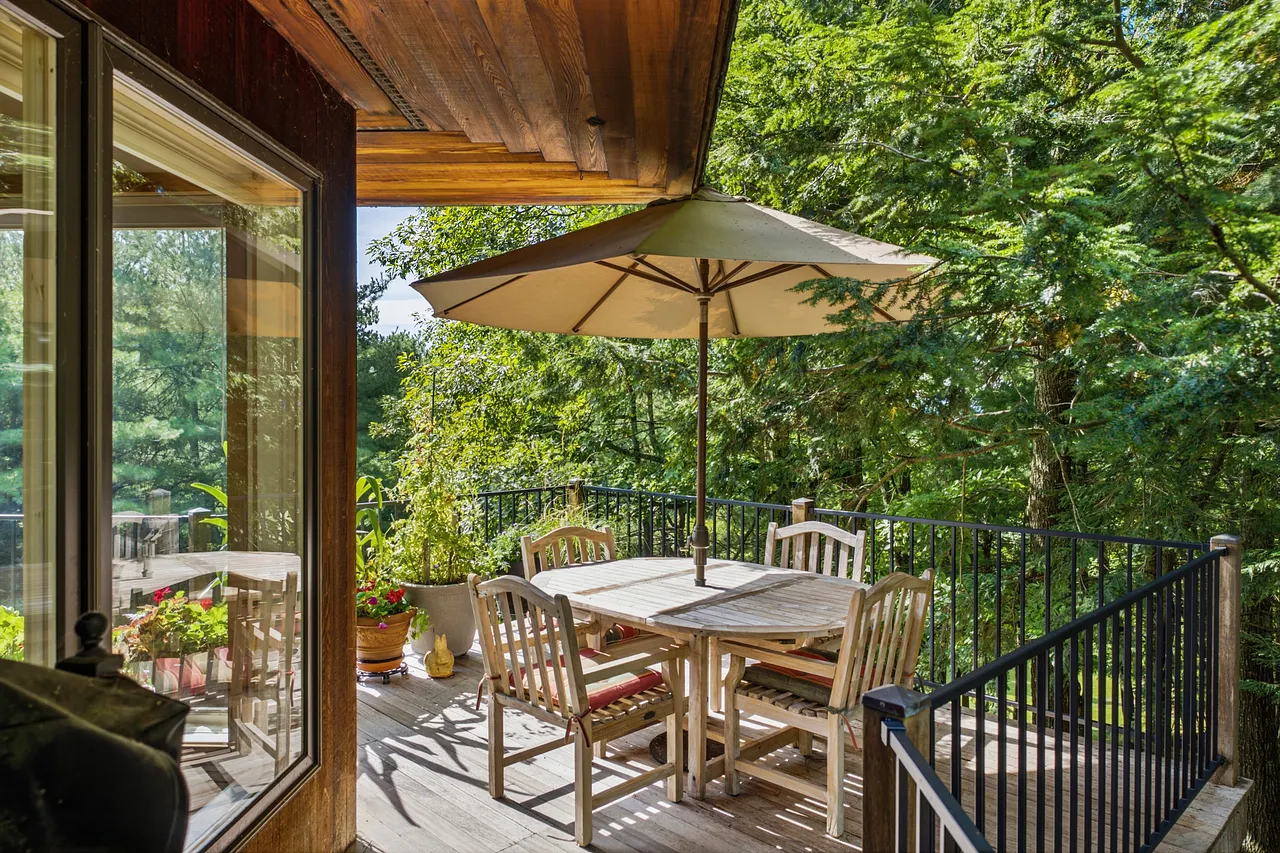 Savor your morning coffee on the expansive, wrap-around mahogany deck while enjoying the tranquil surroundings.
