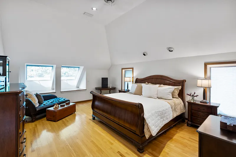Airy primary bedroom with vaulted ceiling